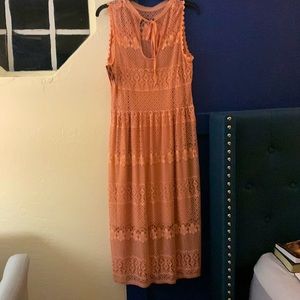 Peach in color, sleeveless, neckline tie, never worn.